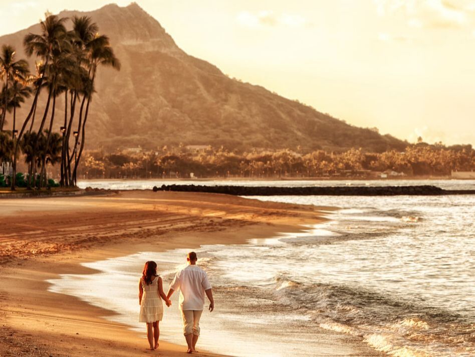 Couple walking on the beach in Hawaii