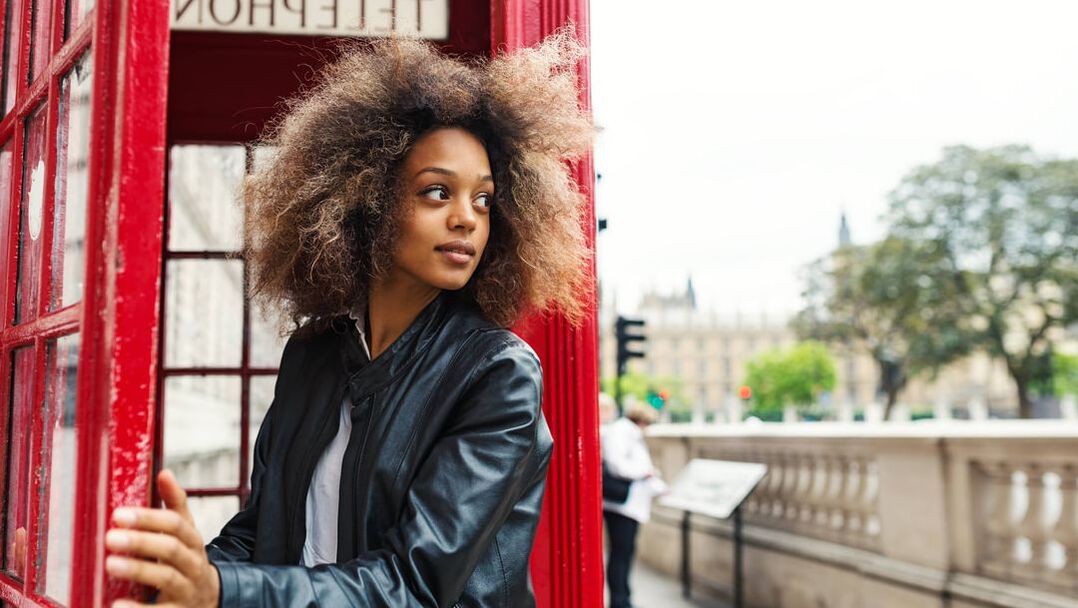 Young woman in London phone booth